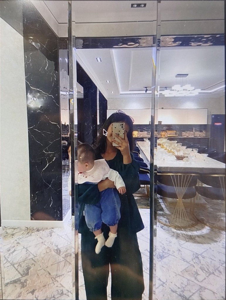 Shahzoda holding a baby warmly